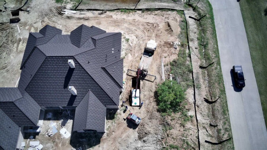 Aerial view of house under construction site.
